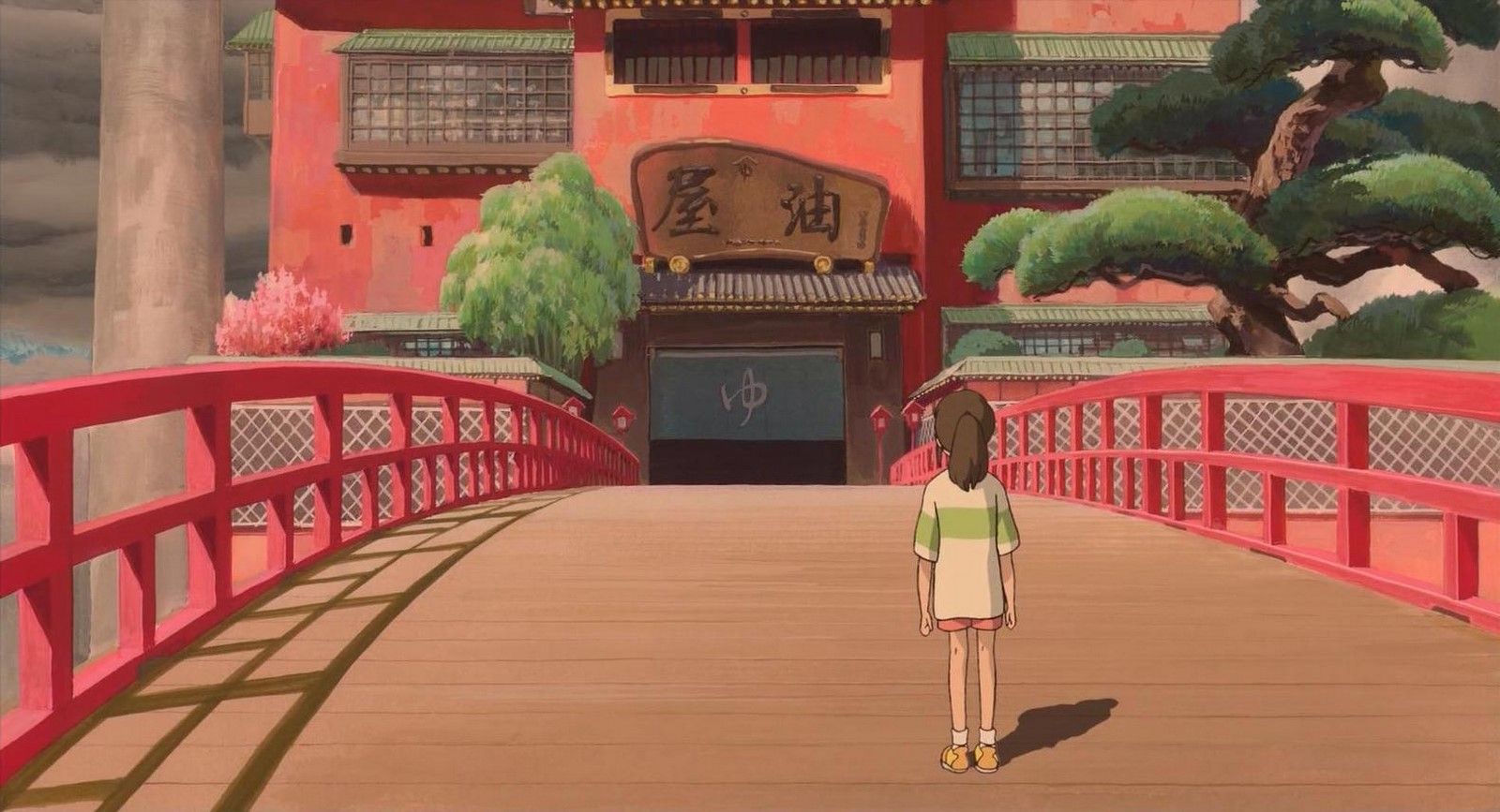 Chihiro standing on the bridge at the bathhouse.