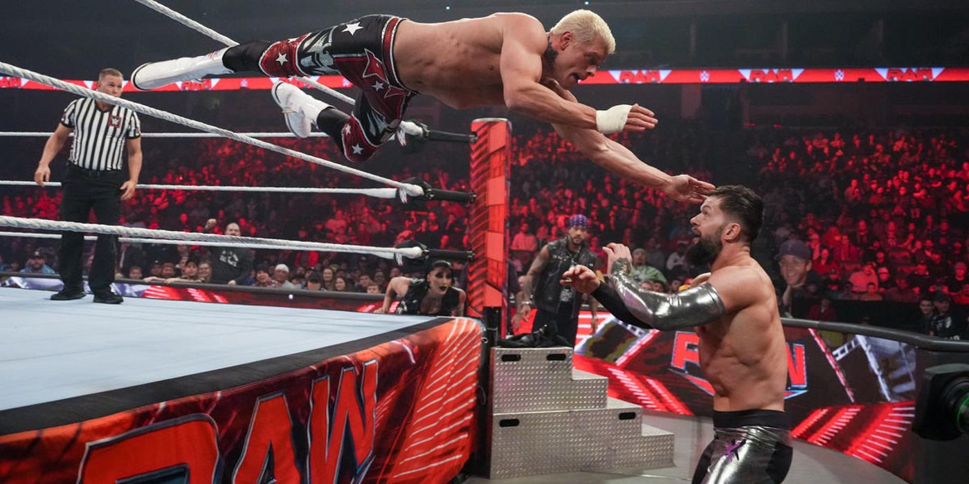 Cody Rhodes dives between the middle and top ropes during his match against Finn Balor on WWE Monday Night Raw in 2023.