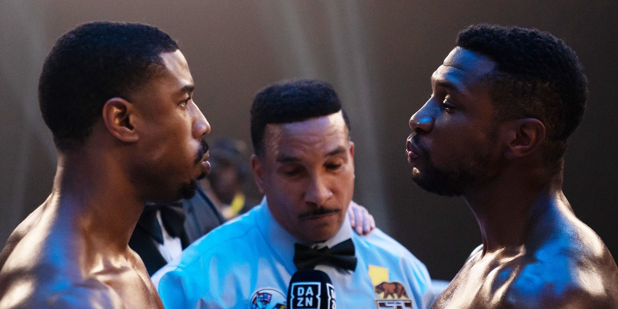 Michael B. Jordan and Jonathan Majors facing each other in the ring in Creed 3