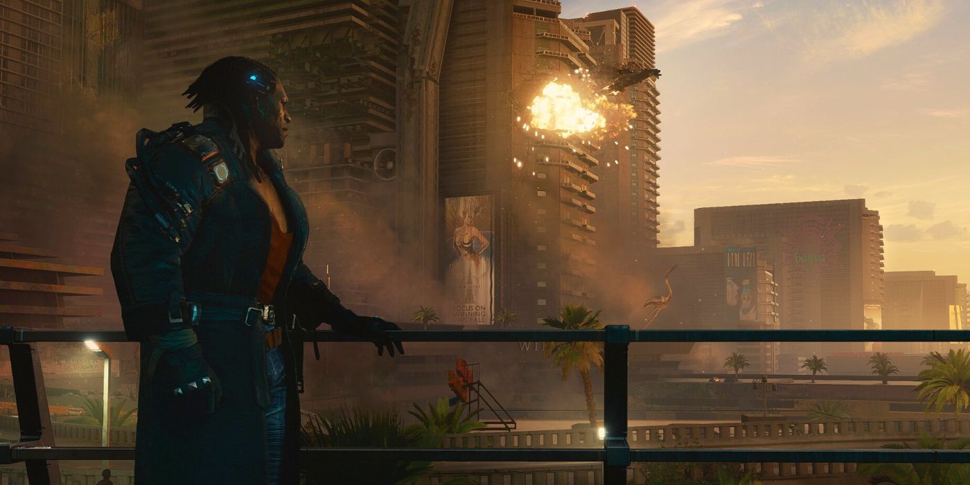 Cyberpunk 2077's Placide standing next to a balcony and looking out across Pacifica as a building explodes in the distance.