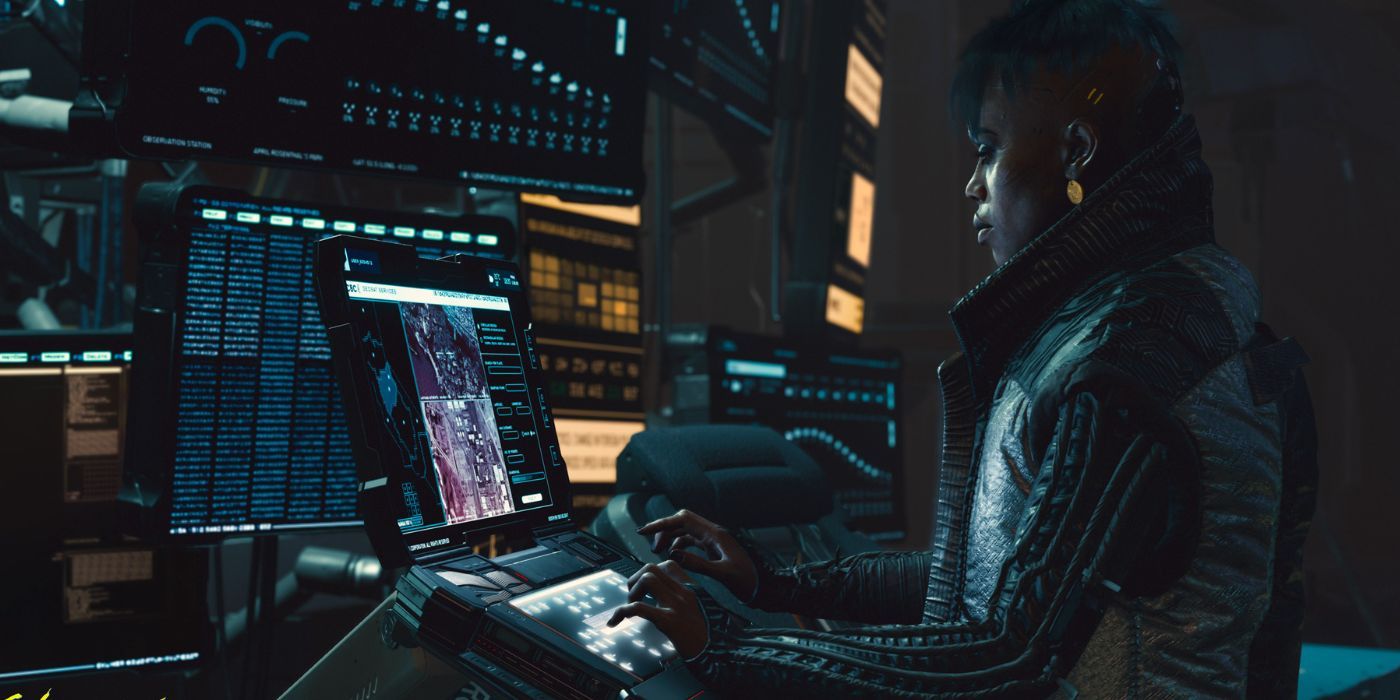 A screenshot of Brigitte looking at a set of screens in Cyberpunk 2077.
