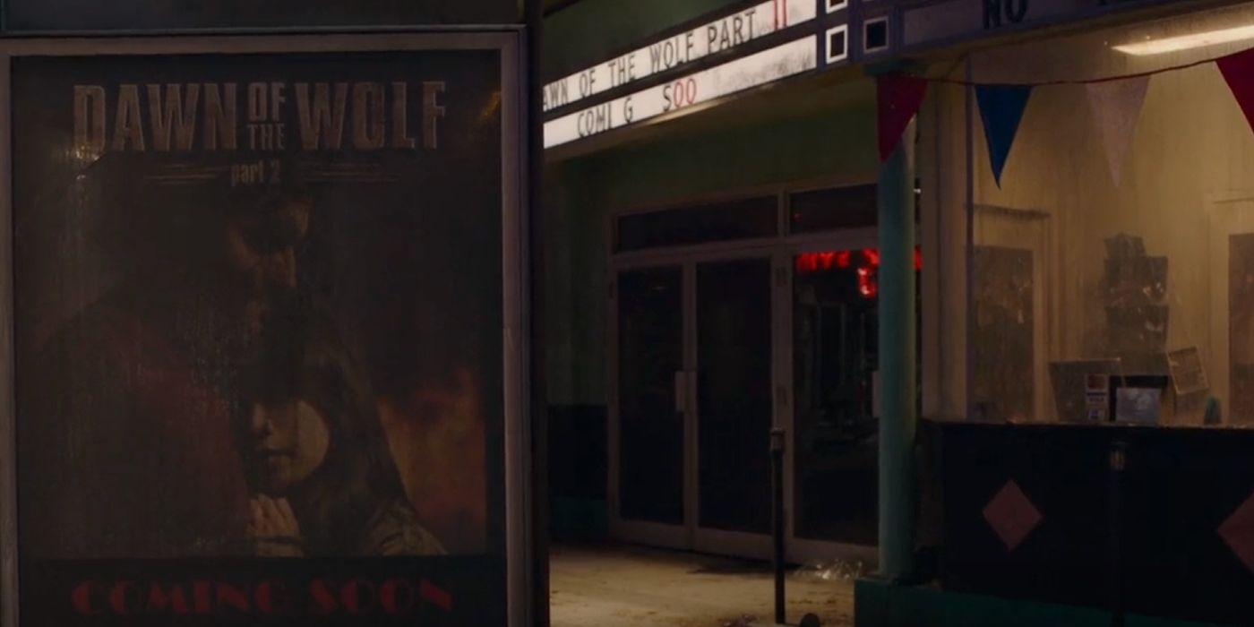A poster for Dawn of the Wolf in front of a theater in The Last of Us episode 7