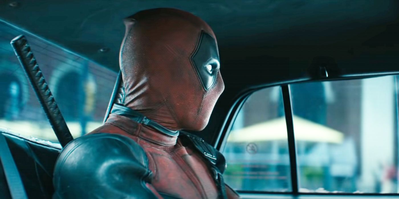 Deadpool sitting in a taxi looking forward