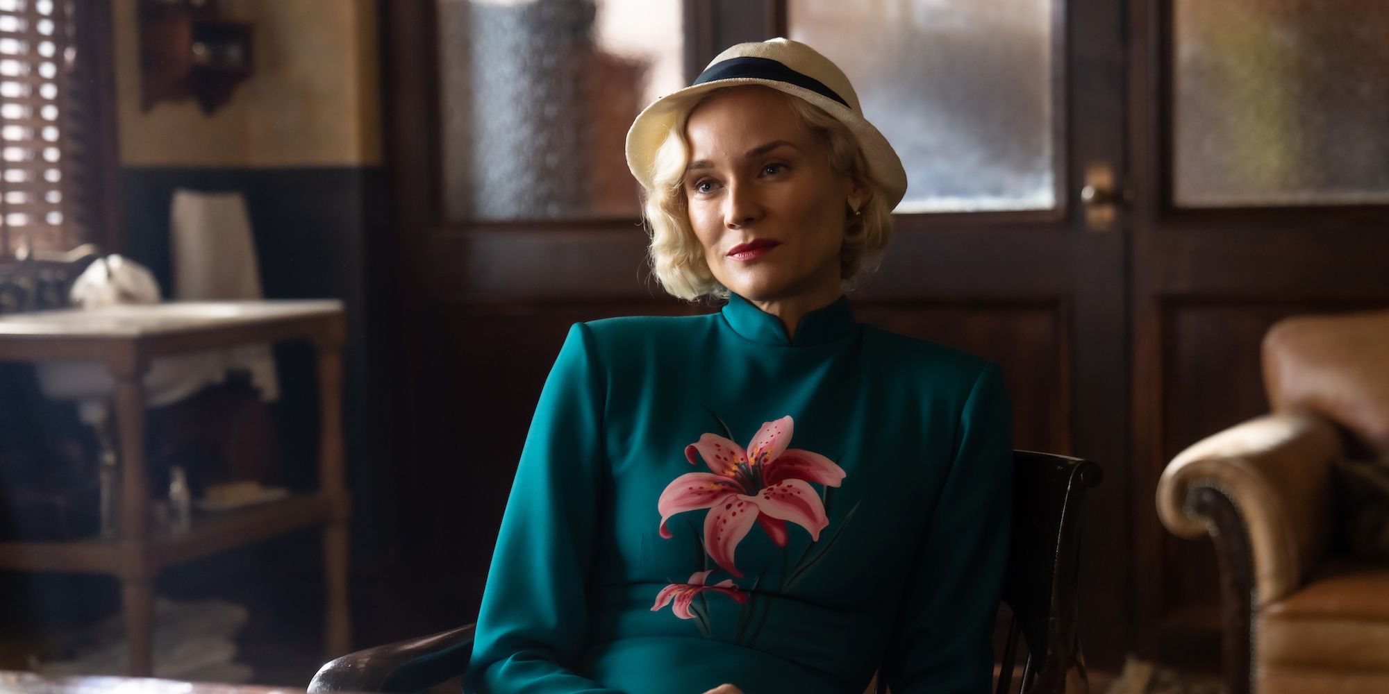 Diane Kruger as Clare Cavendish, sitting in front of a desk looking serious in Marlowe