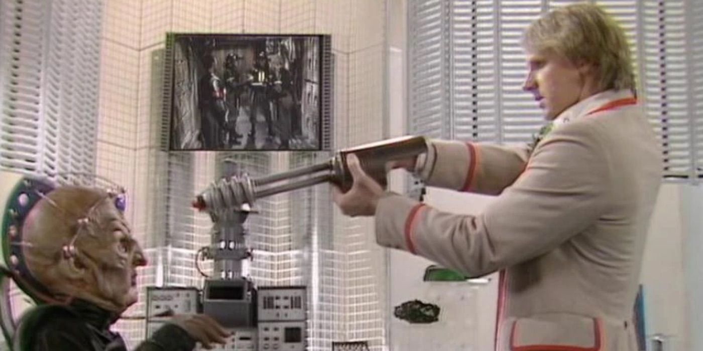 The Doctor points a gun at Davros' head in Doctor Who