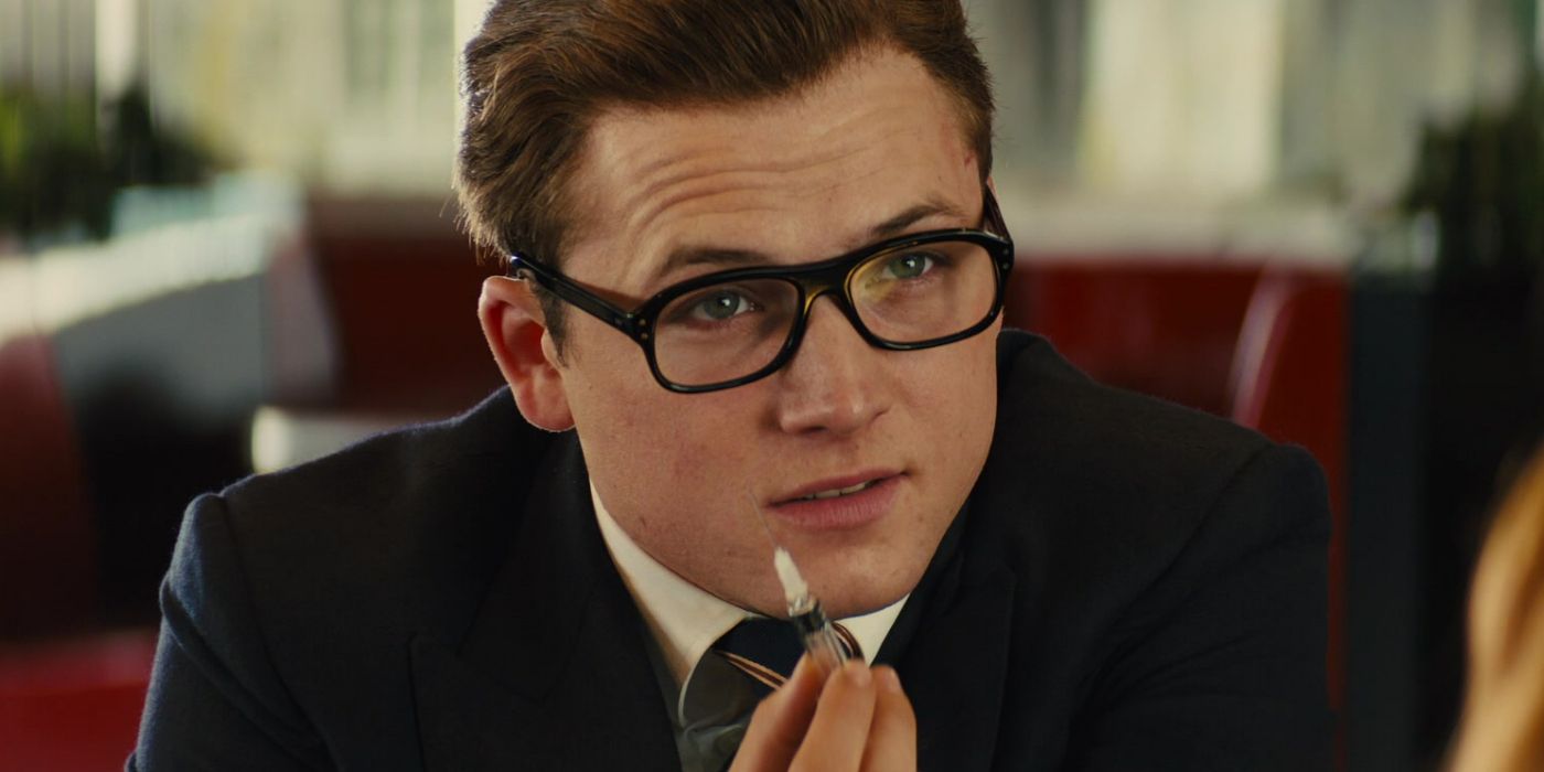 Eggsy holding on to a needle while watching the villain in Kingsman 2