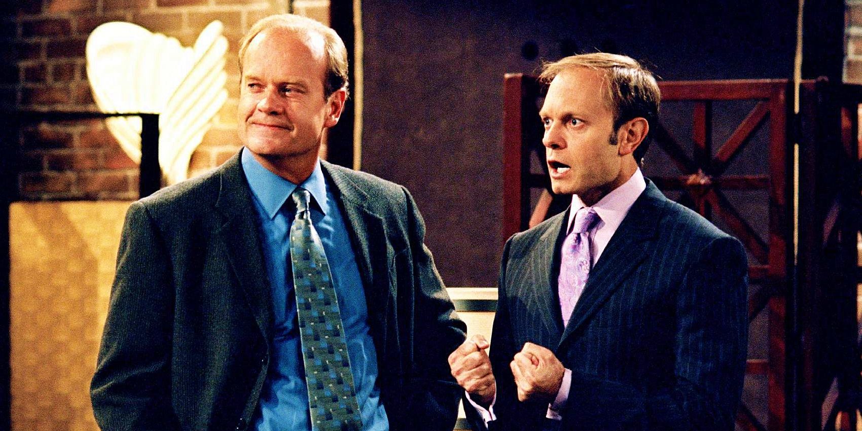 Frasier smiling while Niles has a surprised look on his face in Frasier