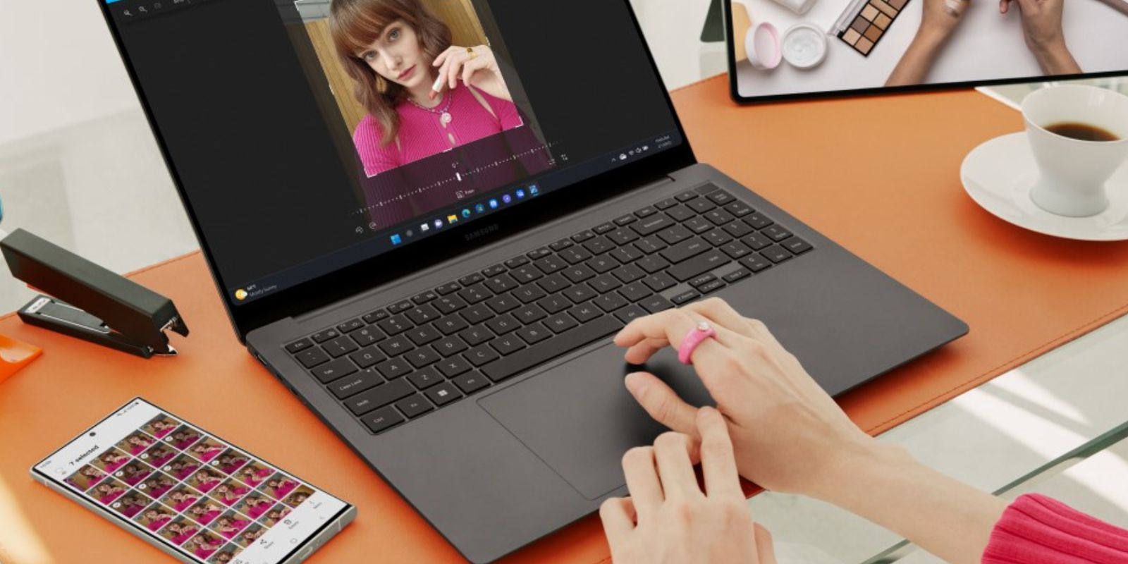 A woman editing a photo on a Galaxy Book with S23 Ultra nearby