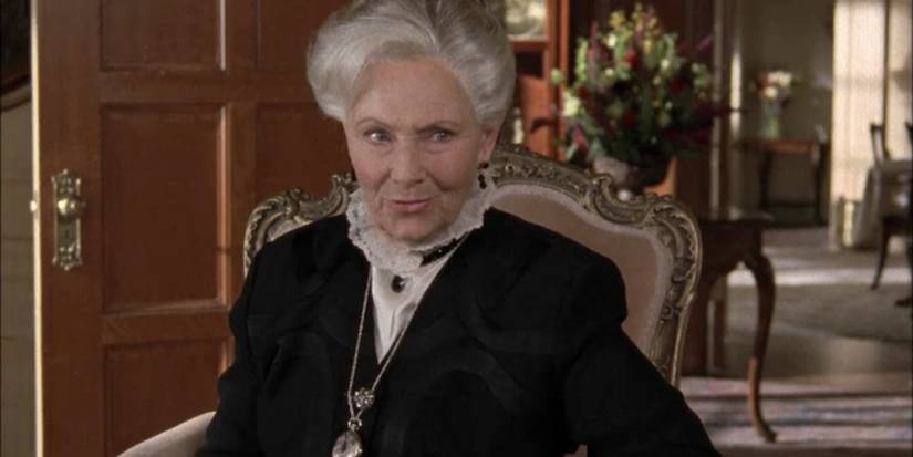 Trix looking serious and sitting in a chair on Gilmore Girls