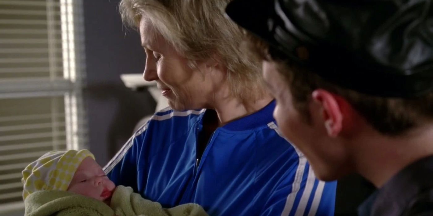 Sue holding her baby Robin with Kurt looking on in Glee