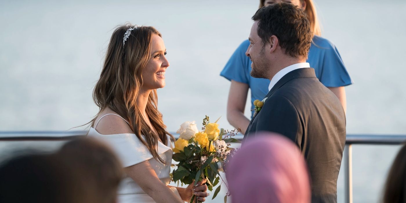 Jo and Alex smiling on their Grey's Anatomy wedding day