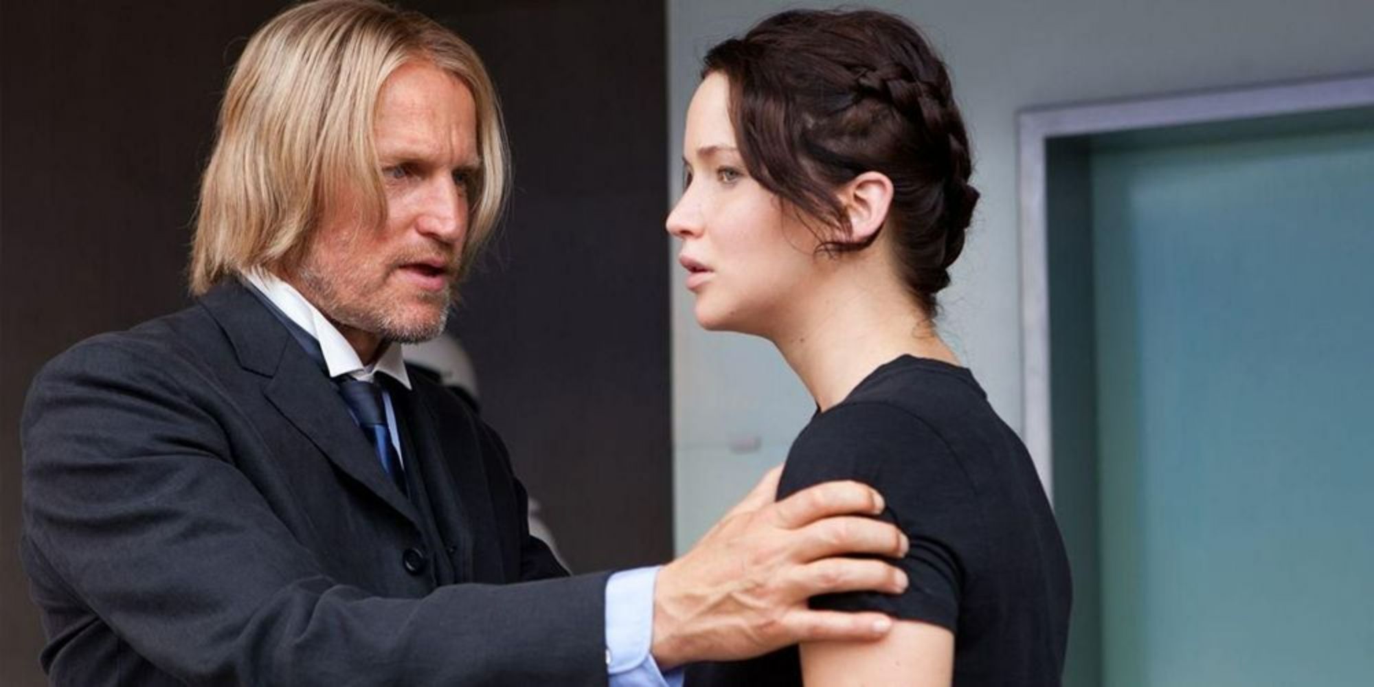 Woody Harrelson como Haymitch conversando com Jennifer Lawrence como Katniss em Jogos Vorazes