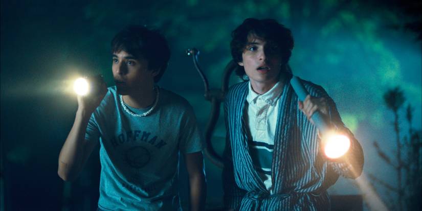 Hell of a Summer Finn Wolfhard and Billy Bryk holding flashlights