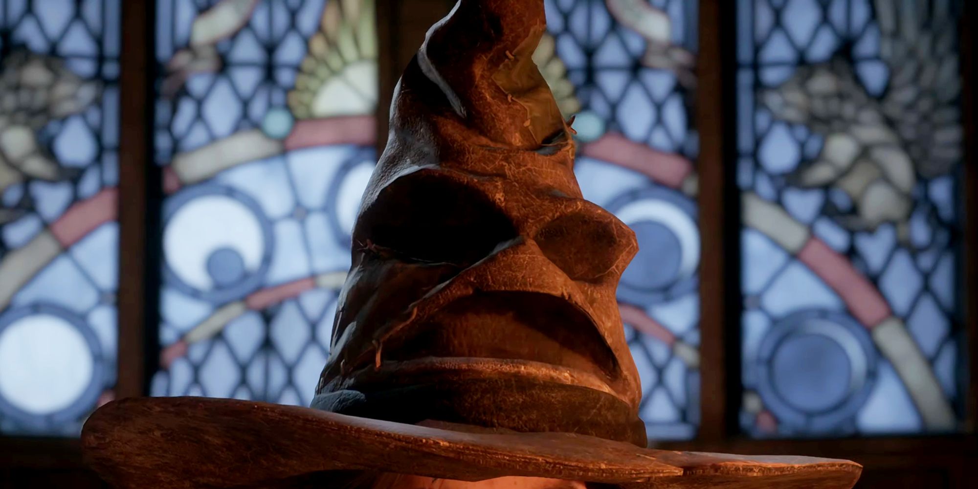 The Sorting Hat sitting on top of a Hogwarts Legacy main character's head, with stained glass windows in the background.