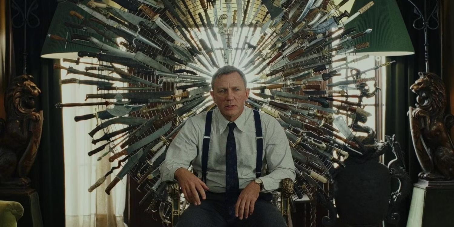 Daniel Craig as Benoit Blanc sitting on a chair of knives sculpture in Knives Out.