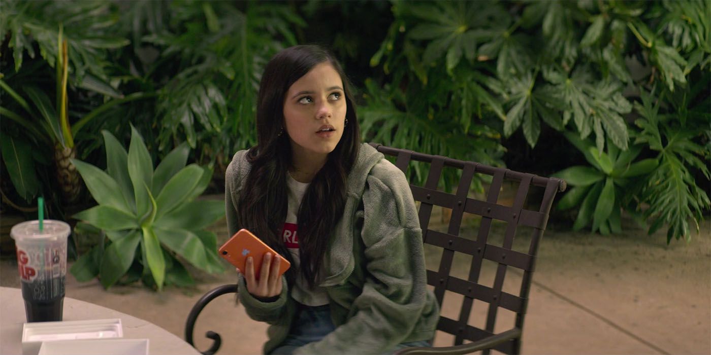 Ellie holding her phone while looking up in You season 2