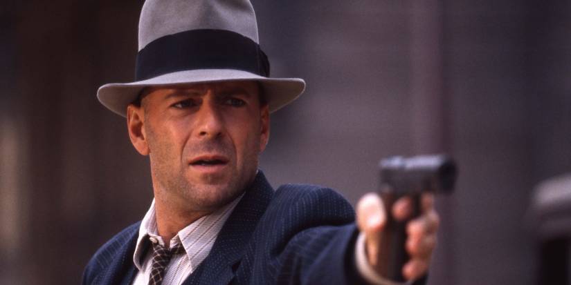 Bruce Willis points a pistol in Last Man Standing 