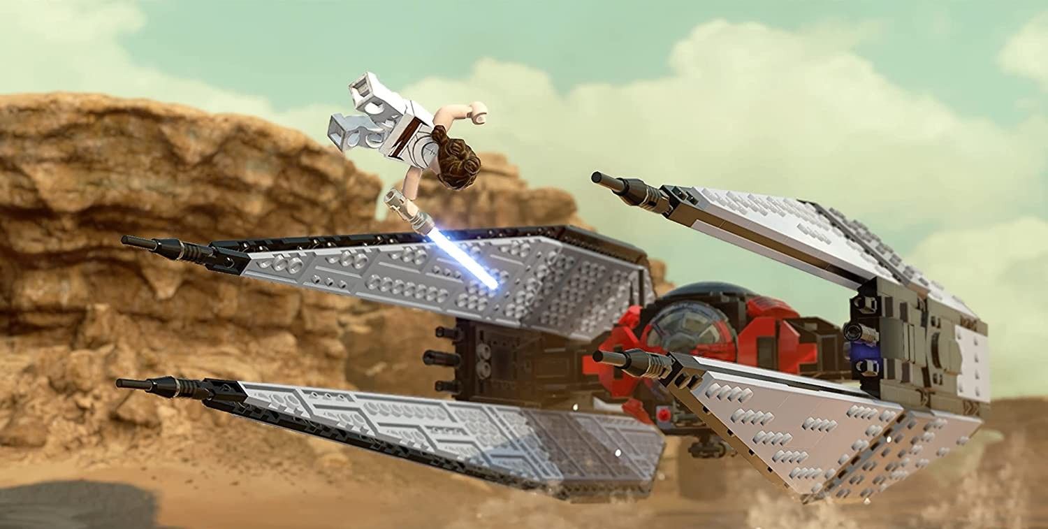 LEGO Rey flipping to attack Kylo Ren's TIE Silencer as it speeds across the desert in LEGO Star Wars: The Skywalker Saga.