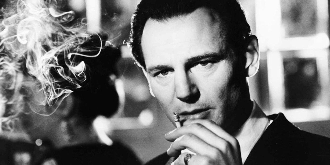 Liam Neeson smoking a cigarette as Oskar Schindler in Schindler's List.