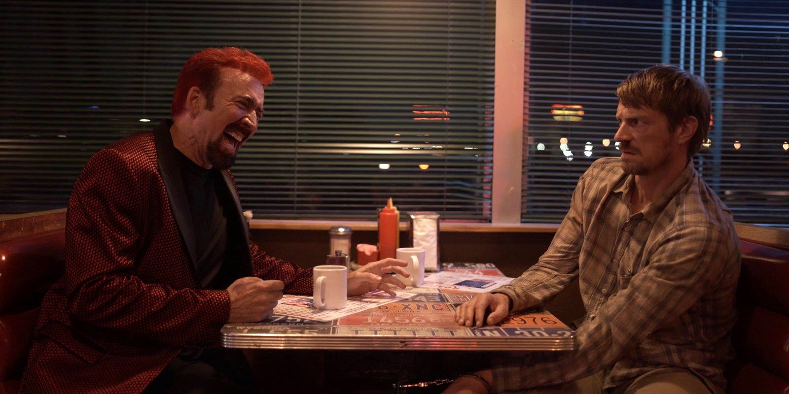Nicolas Cage laughing opposite Joel Kinnaman in Sympathy For The Devil header