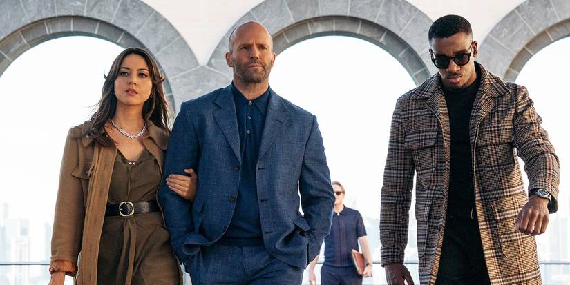 Sarah (Aubrey Plaza), Orson (Jason Statham), and J.J. (Bugzy Malone) walking together in Operation Fortune movie