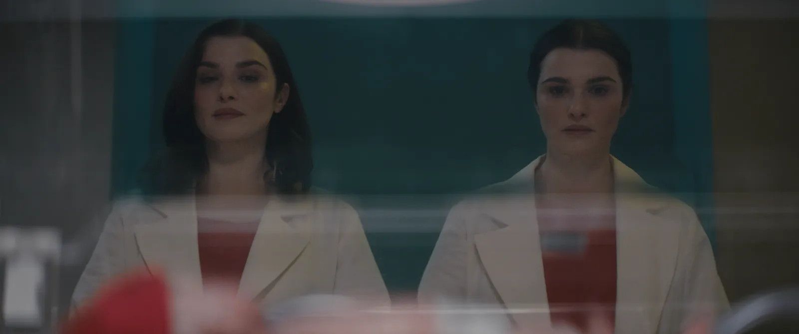 Rachel Weisz as twins doctors in Dead Ringers, looking identical except one has her hair hanging long and the other has it up