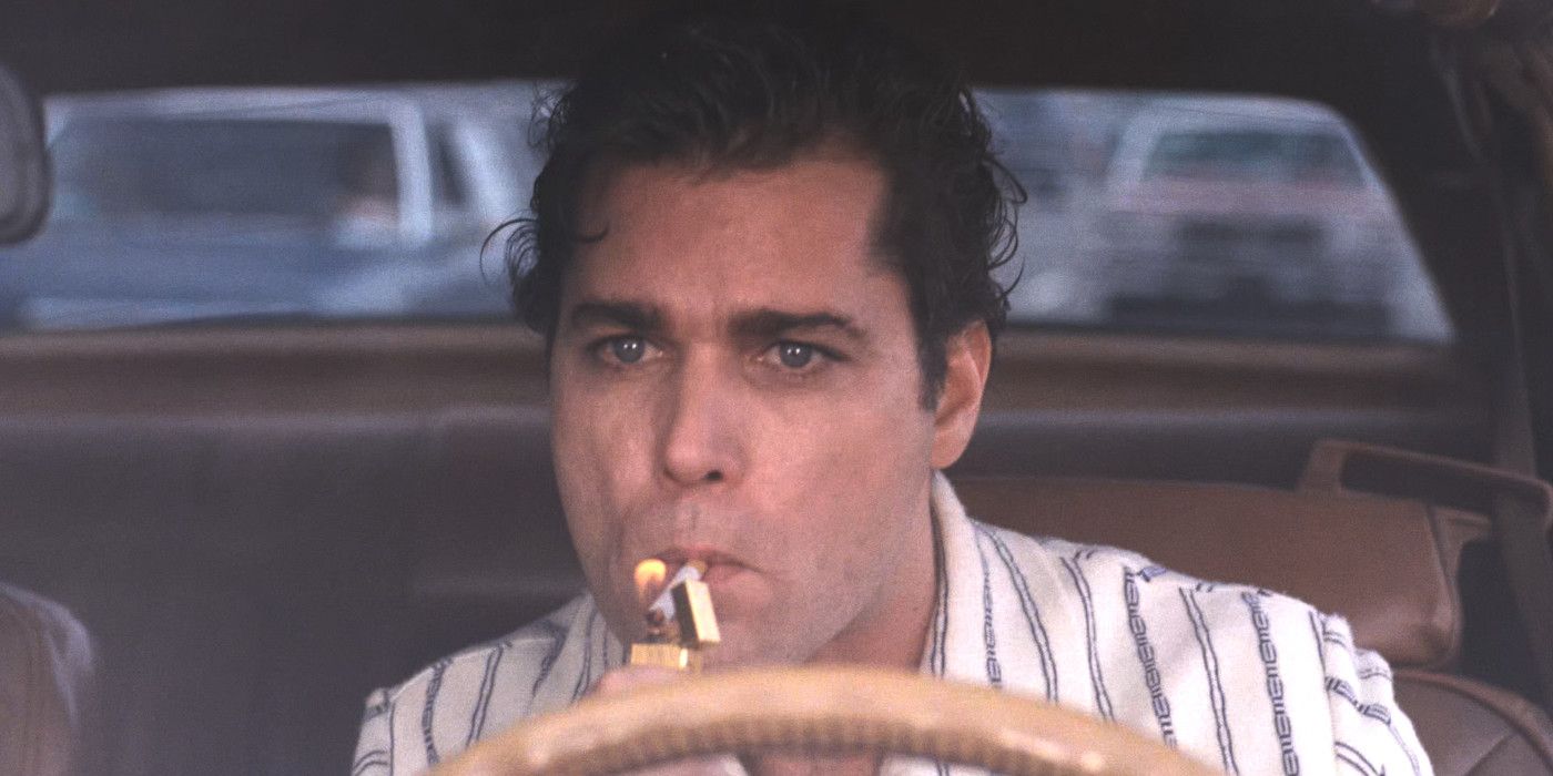 Ray Liotta as Henry Hill in Goodfellas driving a car, lighting a cigarette, and looking red-eyed and strung out.