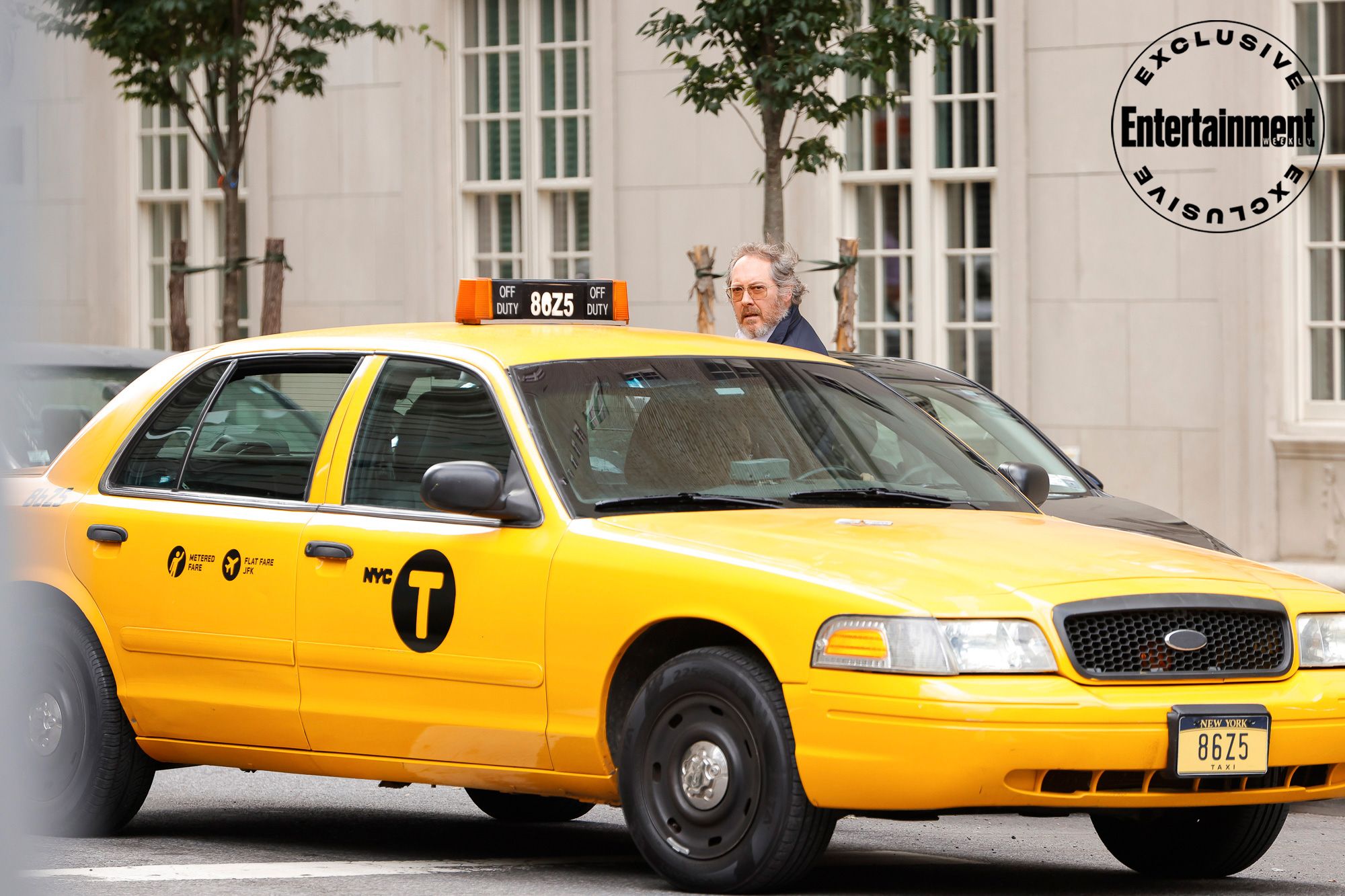 Reddington getting in a taxi with a beard and hair in The Blacklist