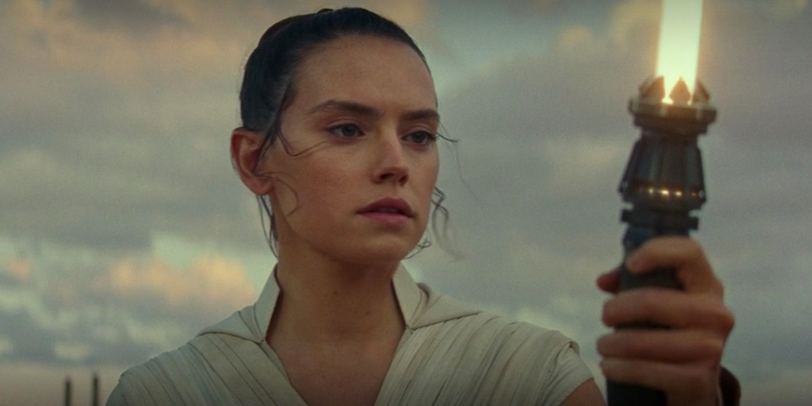 Rey (Daisy Ridley) with a yellow lightsaber in Star Wars: The Rise of Skywalker.