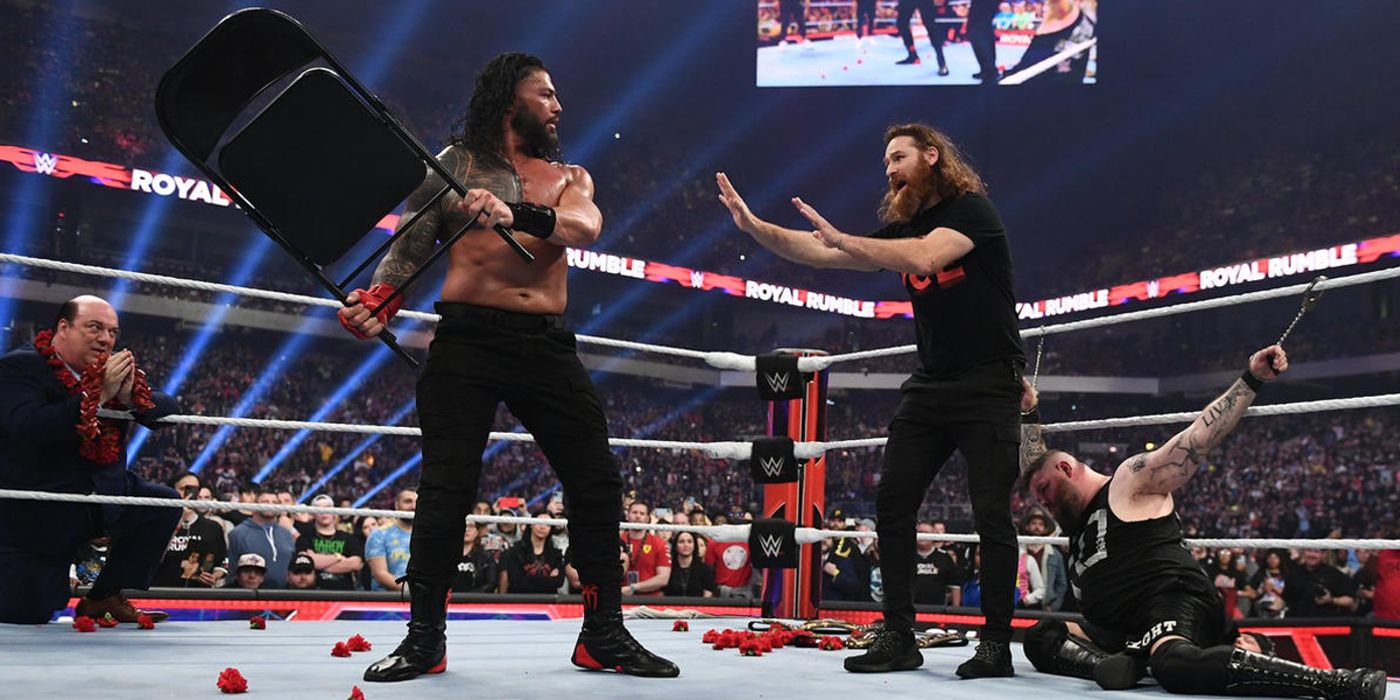 Sami Zayn prevents Roman Reigns from striking Kevin Owens with a chair during the Royal Rumble in 2023.