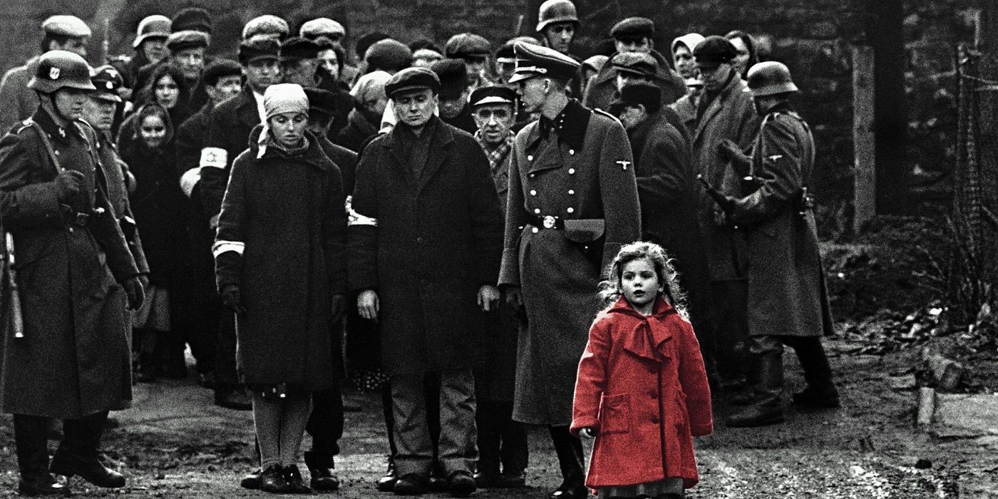 Little girl in a red coat surrounded by adults in black and white.