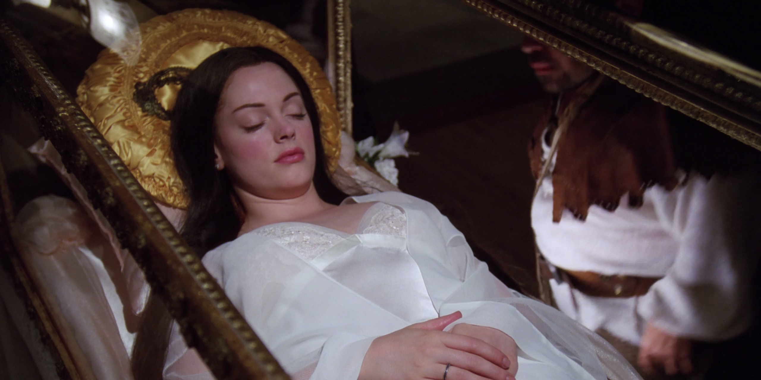 Paige in a glass coffin after eating Snow White's apple in Charmed
