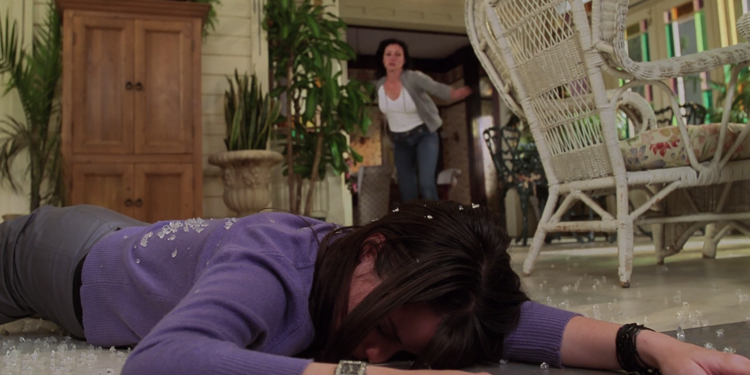 Piper lying on top of Charmed in a pile of broken glass