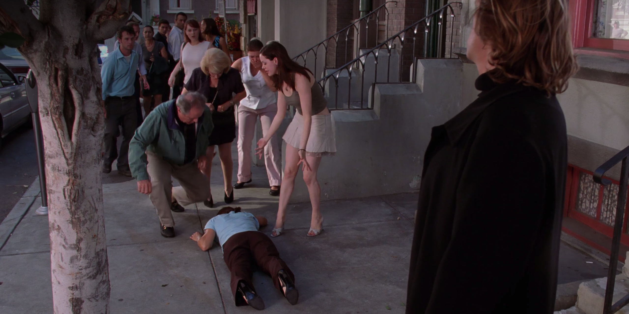 An Angel of Death looks on as Paige looks down at Piper's body in horror on Charmed