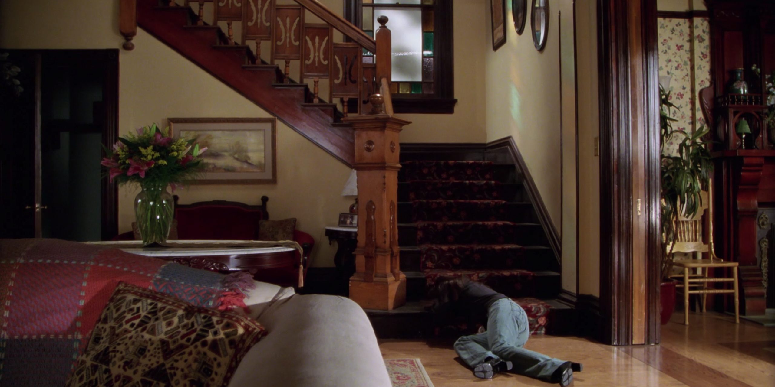 Piper's body slumped by the stairs on Charmed