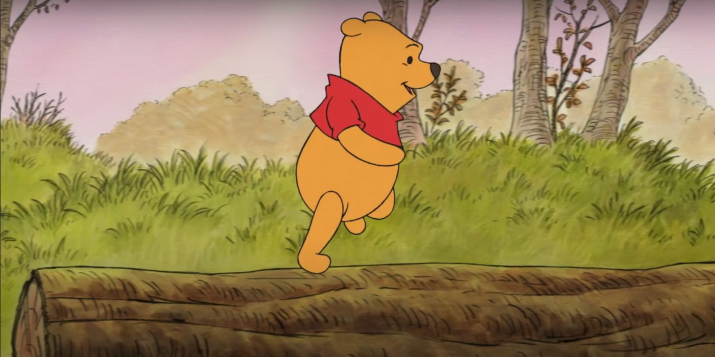 An animated Winnie the Pooh running on a log
