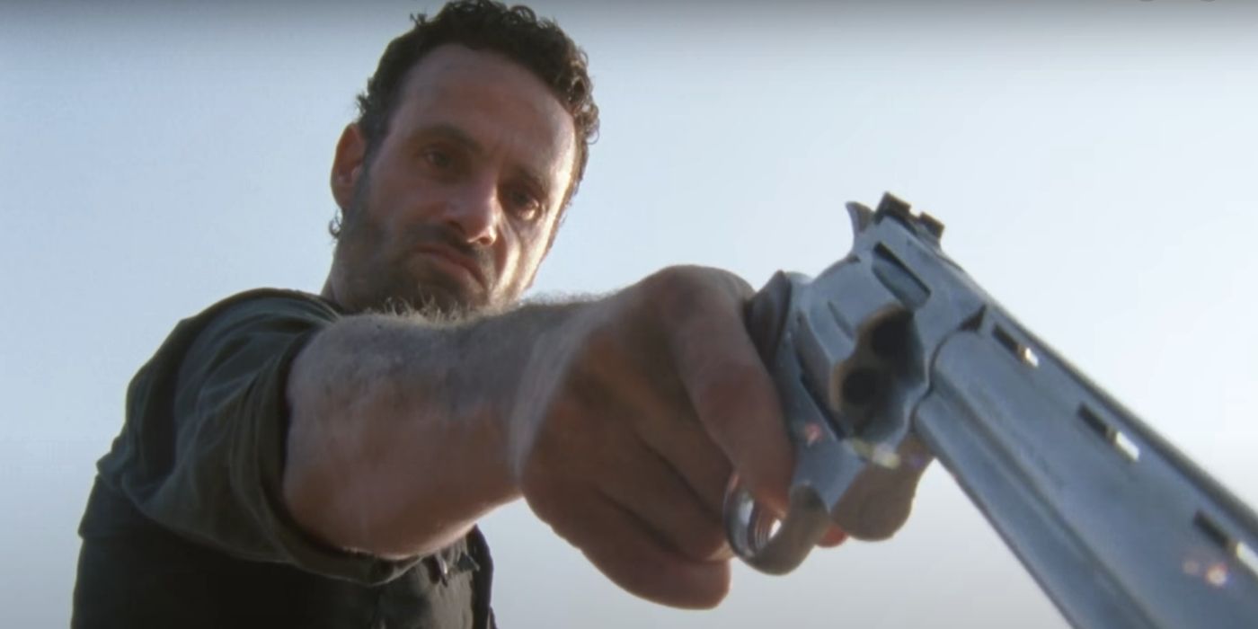 Rick Grimes pointing a gun out of frame in The Walking Dead