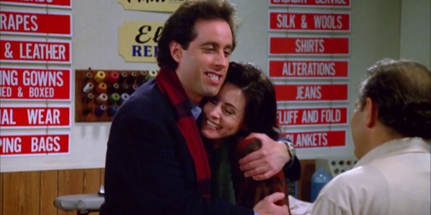 Jerry and Meryl smiling and hugging at the dry cleaner's on Seinfeld