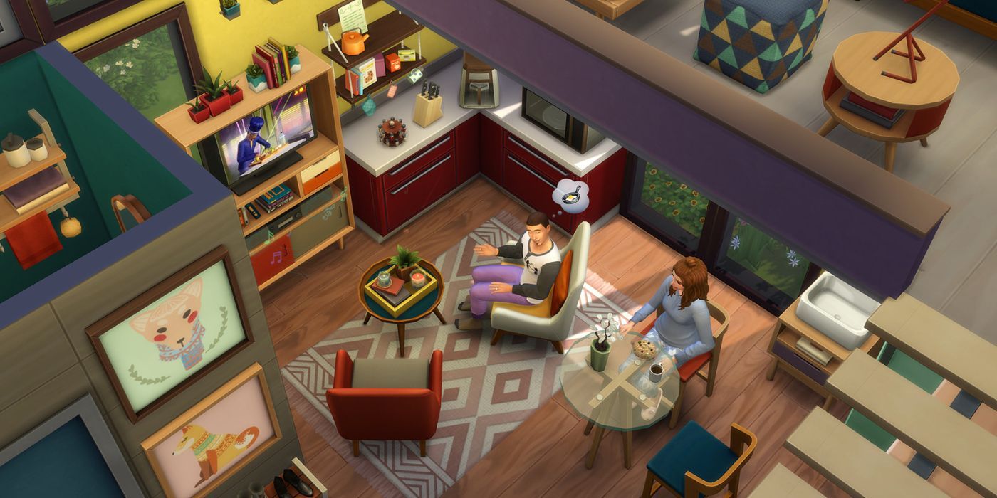 Uma foto de cima para baixo de uma casa construída com o Tiny Living Stuff Pack no The Sims 4, com um loft e uma pequena combinação de cozinha/área de estar.