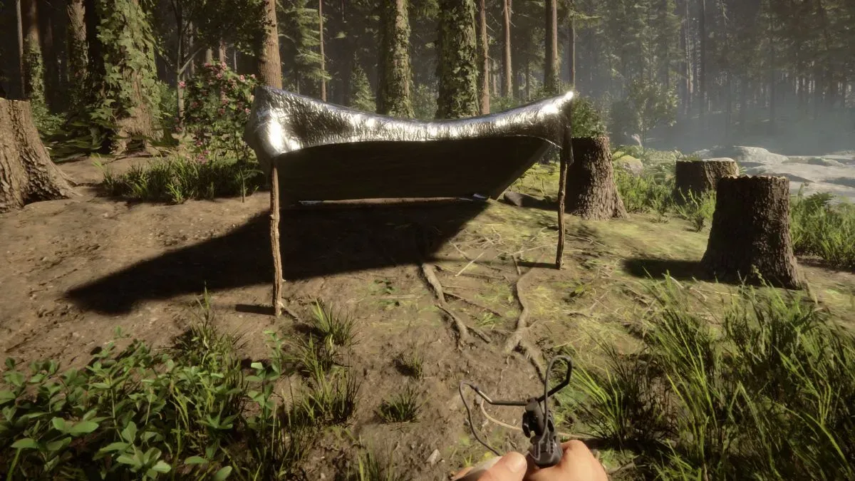 A tent made of two sticks and a silver tarp in Sons of the Forest