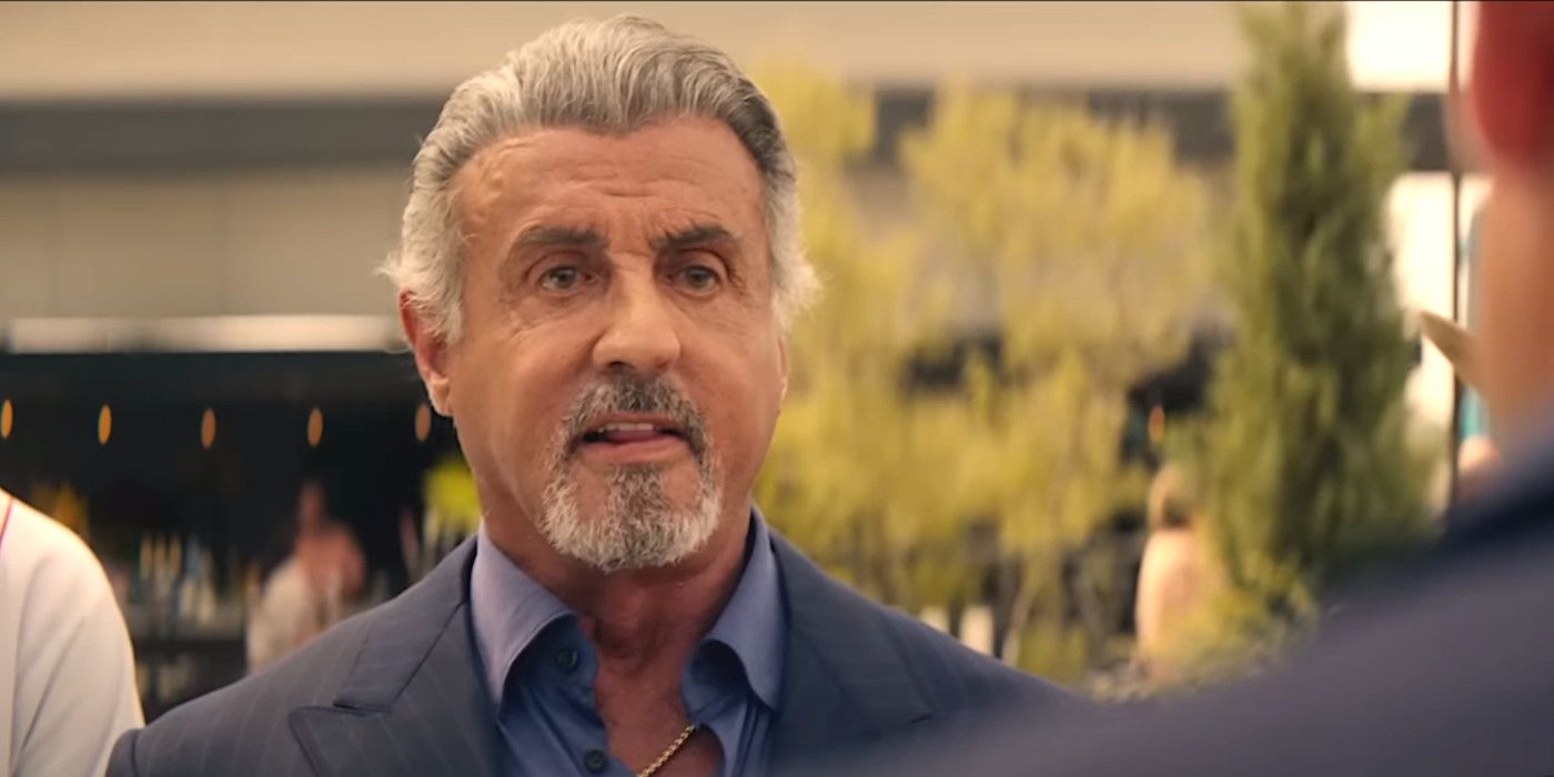 Sylvester Stallone in Tulsa King season 1 with gray hair and goatee being confrontational in the street
