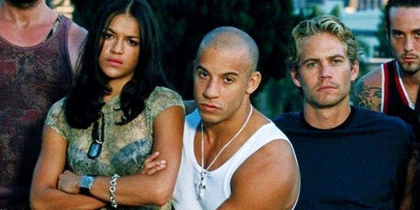 The Fast and the Furious 2001 cast Vin Diesel, Michelle Rodriguez, Paul Walker standing together