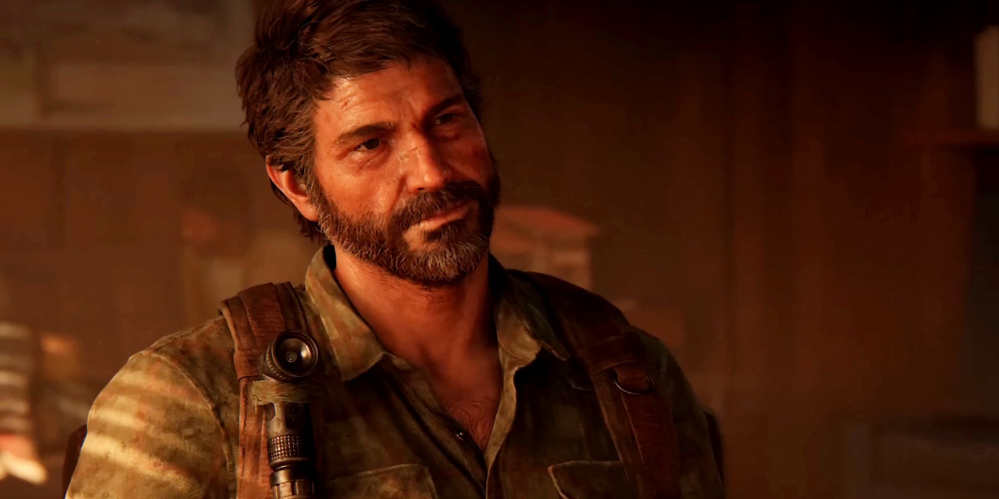 Joel from The Last of Us Part 1, sitting in a chair while he talks to Henry, who is out of frame to the right.