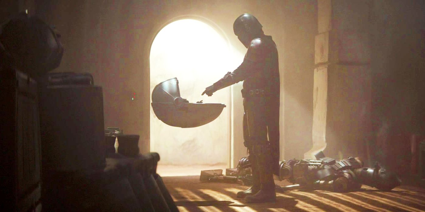 The Mandalorian pointing at Baby Yoda in The Mandalorian Chapter 1
