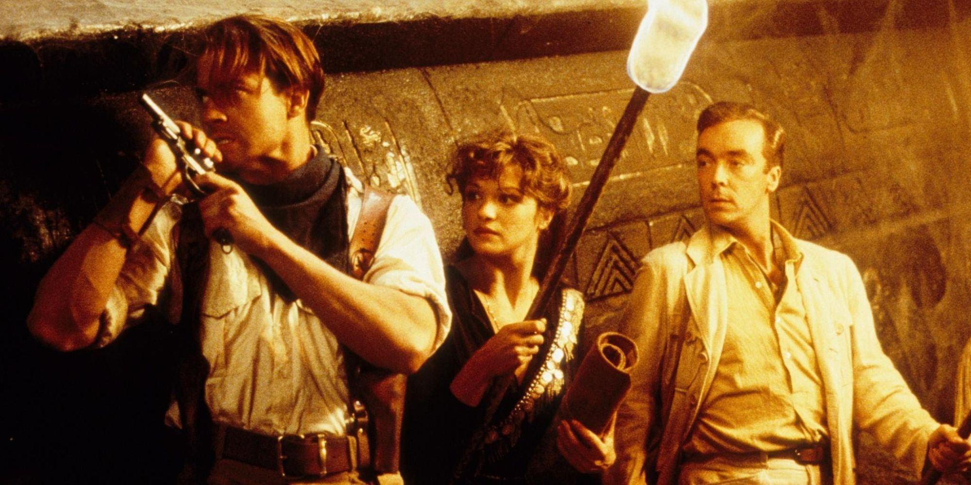 Rick leads Evelyn and her brother through a tomb in The Mummy