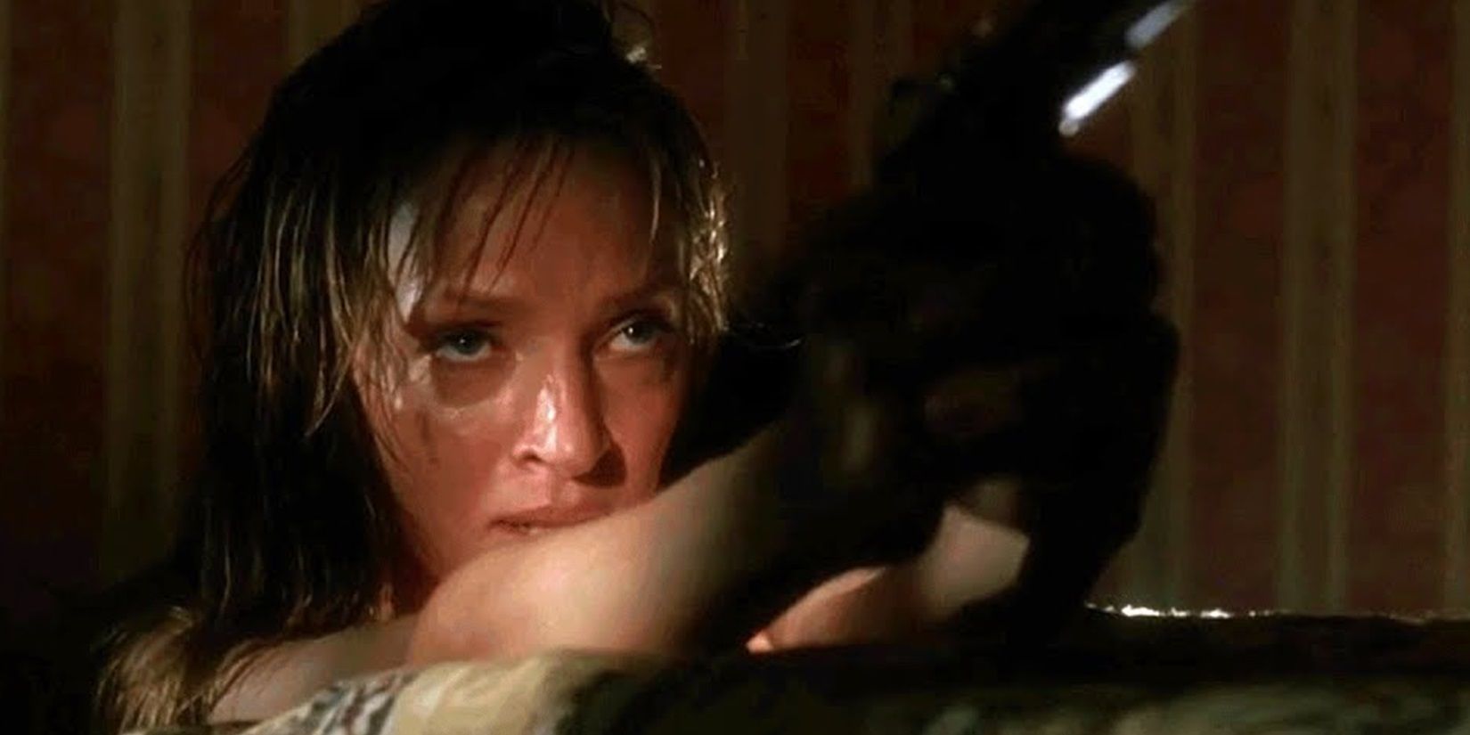 The Bride with a gun in a hotel room in Kill Bill