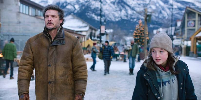 Joel (Pedro Pascal) and Ellie (Bella Ramsey) walking in Jackson in The Last of Us