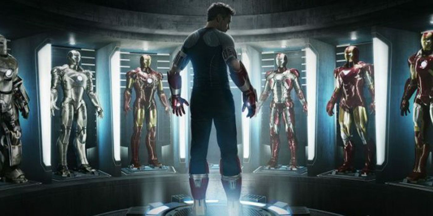 Tony Stark standing in front of his suits in the MCU