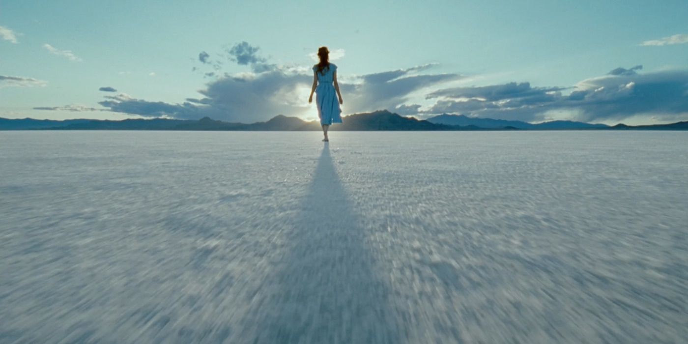 A woman walks on a salt flat in The Tree of Life 