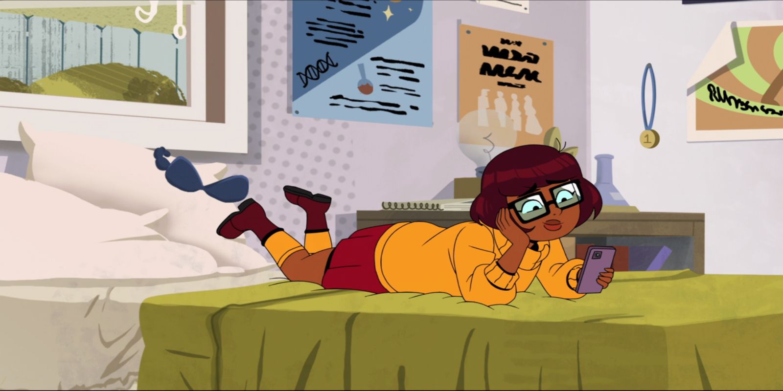 Velma laying on her bed in HBO Max's Velma